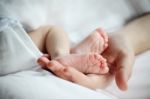 Baby's Feet In Mother Hand Closeup Stock Photo