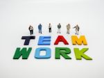 Miniature Bussinessman With Teamwork Word Letters On White Backg Stock Photo