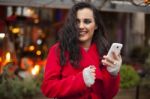 Woman In Red Coat With Mobile Phone In Hands, Smartphone, Urban Stock Photo