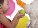 Teddy Bear Eating Apple Stock Photo