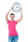 Pretty Girl Holding The Wall Clock Stock Photo