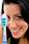Front View Of Smiling Woman With Toothbrush On White Background Stock Photo