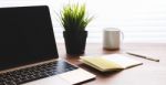 Office Desk With Laptop And Notebook Stock Photo