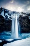 View Of Seljalandfoss Waterfall In Winter Stock Photo