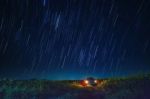 Night Scene Of Star Tail And Blue Sky Over Car Parking In Agriculture Field Stock Photo