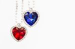 Two Jewelry Hearts Blue And Red Hanging Together On White Stock Photo