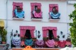 Traditional Spanish Dresses Adorning Balconies On A Building In Stock Photo
