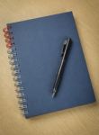 Pen And Notebook On Wooden Table Stock Photo