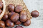 Roasted Chestnuts On Wooden Stock Photo
