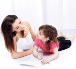 Woman And Child Drawing On Notepad Stock Photo