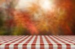 Picnic Table With Blurred Autumn Leaves Background Stock Photo