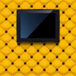 Yellow Leather Wall With Black Lcd Tv Stock Photo