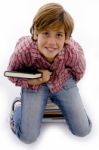 Top View Of Little Boy Holding Book Stock Photo