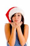 Female Wearing Christmas Hat And Giving You Flying Kiss Stock Photo
