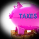 Taxes Piggy Bank Coins Means Taxed Income And Tax Rate Stock Photo