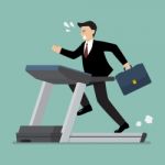 Businesswoman Running On A Treadmill Stock Photo