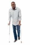 African Man With Crutches Trying To Walk Stock Photo