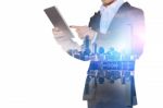 Double Exposure Of Businessman Holding Tablet With Cityscape Blurred Background, Business Concept Stock Photo