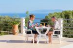 Married Couple Man And Woman Eating At Table On Terrace Near Sea Stock Photo