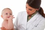 Female Pediatrician Checking Baby Boy Stock Photo