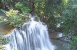 The Water Flowing Over Rocks And Trees Down A Waterfall At Huay Mae Khamin Waterfall National Park ,kanchana Buri In Thailand Stock Photo