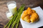 Croissant On Dish With Rice Milk And Ear Of Rice  On Old Wooden Stock Photo