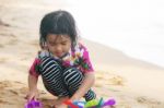 Girl Playing Toy On Beach Stock Photo