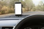 Phone And Mounted Holder In Car On Rural Road Stock Photo