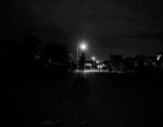 Boy Walking Alone At Night Under The Street Lights Stock Photo