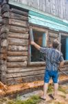 Man Repairing A Wooden House Stock Photo