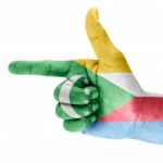 Flag Of The Comoros On Shooting Hand Stock Photo