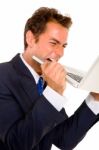 Business Man Biting Laptop Stock Photo