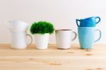 Mugs And Cups On Kitchen Table Stock Photo