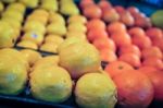 Lemon And Oranges On Produce Shelf Stock Photo