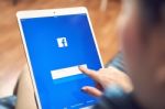 Bangkok, Thailand - January 16, 2018 : Hand Is Pressing The Facebook Screen On Apple Ipad Pro,social Media Are Using For Information Sharing And Networking Stock Photo