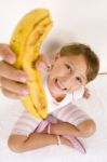 Little Girl Showing You Banana Stock Photo