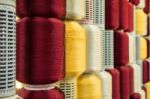 Red And Yellow Silk Thread In Spool Stock Photo