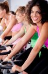 People Spinning On Bicycles In A Gym Stock Photo