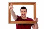 Man With Wooden Picture Frame Stock Photo