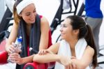 Women Relaxing In The Gym After Making Exercise Stock Photo