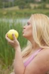 Pregnant Woman Eating Apple Stock Photo
