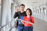 Younger Asian Traveling Man And Woman Standing With Toothy Smiling Face Sigh All Right By Okay Hand Sue For Modern People Backpacker Traveling Lifestyle Stock Photo