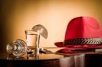 Glass Of Vodka And Classical Guitar With Red Hat Stock Photo