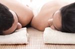 Young Man And Woman Lying On Towel To Take Spa Stock Photo