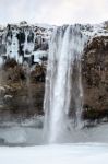 View Of Seljalandfoss Waterfall In Winter Stock Photo