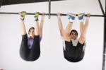Male And Woman Exercising In Bar Stock Photo