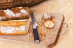 Rye And Wheat Bread Loafs And A Knife On Wooden Cutting Board Stock Photo