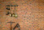 Brick Wall With A Spade And Ladle Hanging Stock Photo