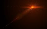 Abstract Digital Lens Flare In Black Background Horizontal Warm Stock Photo