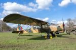 Old Military Airplane On Green Grass With Blue Sky And White Clo Stock Photo